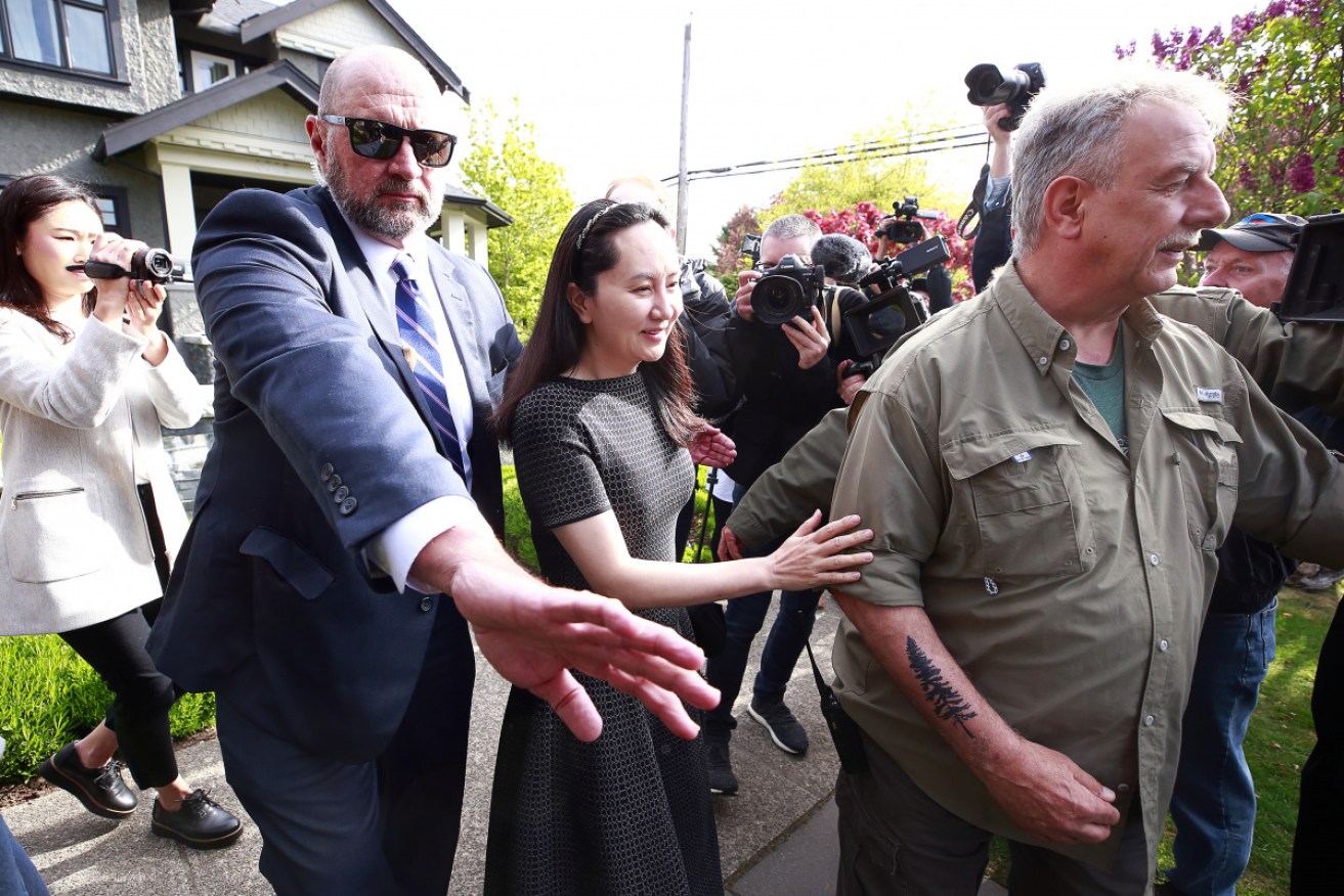 Meng Wanzhou leaves home in Vancouver, bound for court.