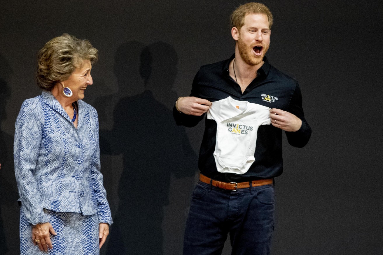Prince Harry is delighted to receive an Invictus Games babygro for his son Archie by Princess Margriet of The Netherlands.