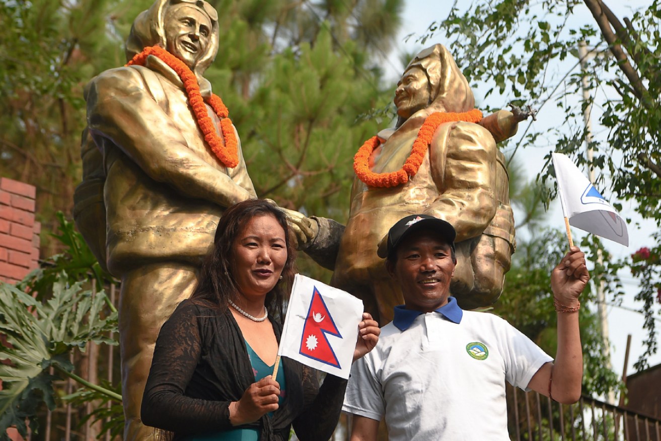 Sherpas Lhakpa and Everest record holder Kami Rita (right) pose in front of Tenzing Norgay and Edmund Hillary statues, the mountain's original conquerors. <i>Photo: Getty</i>