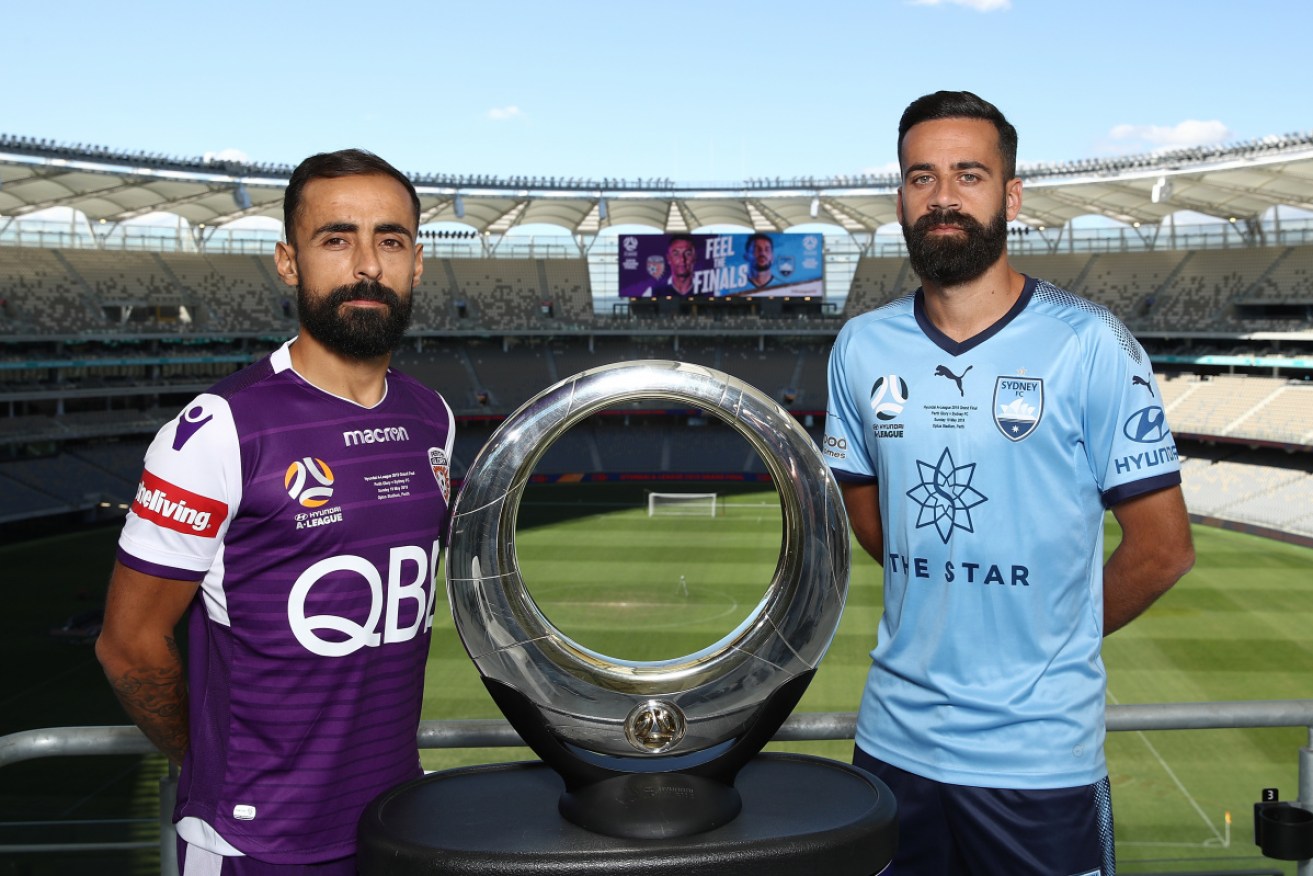 Diego Castro of the Glory and Alex Brosque of Sydney pose with the A-League Champions trophy during a media opportunity ahead of Sunday's A-League Grand Final at Optus Stadium. 
