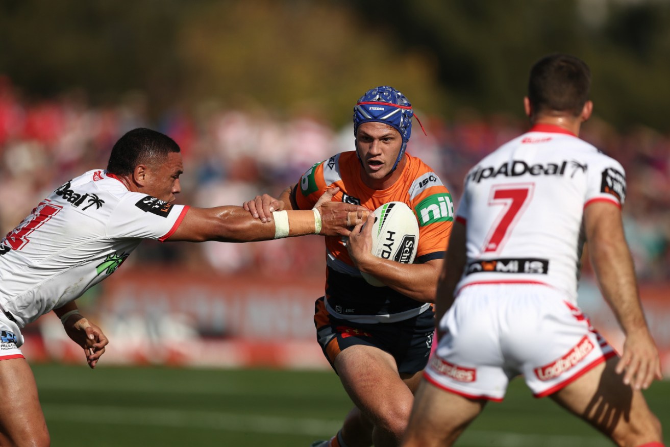 Knights star Kalyn Ponga eludes the Dragons' defence. 