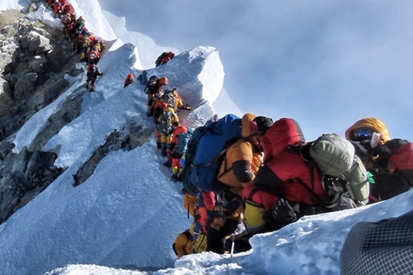 Climbers queue to reach the summit of the world's highest mountain.