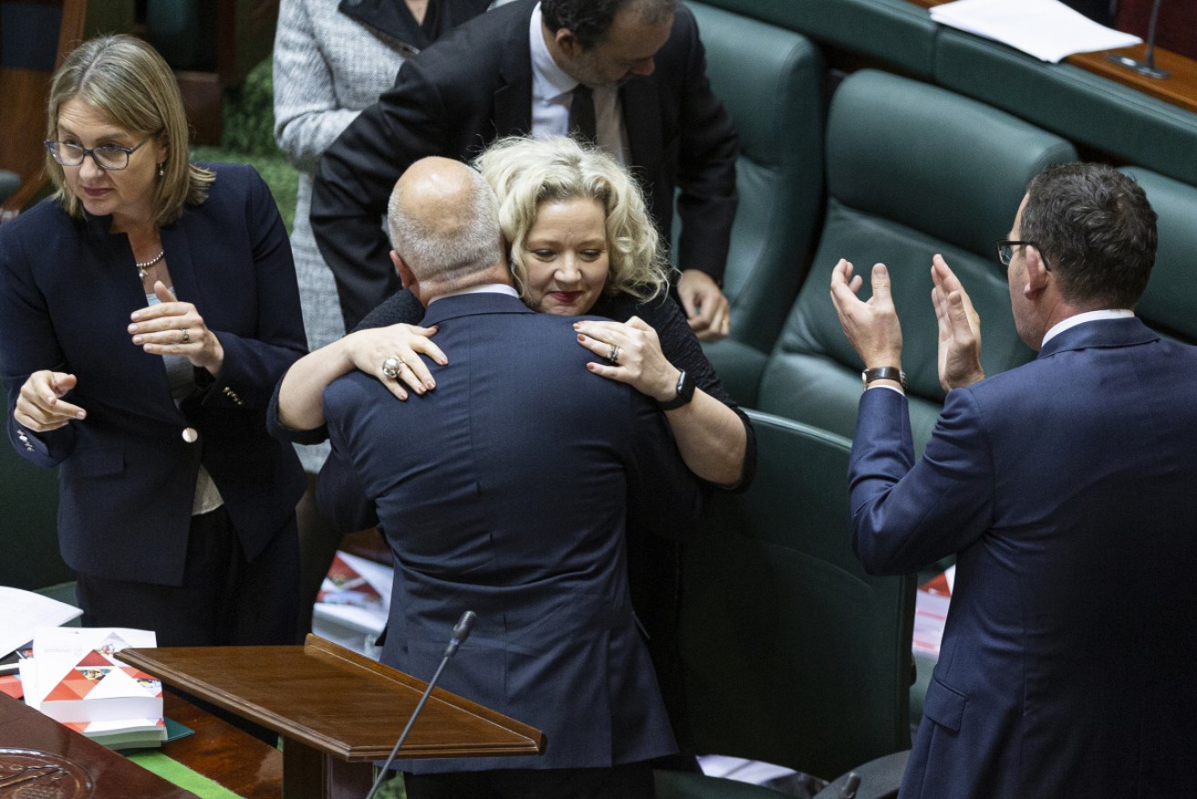 Victorian Treasurer Tim Pallas is congratulated by colleagues after speaking during the Victorian Budget hand down.