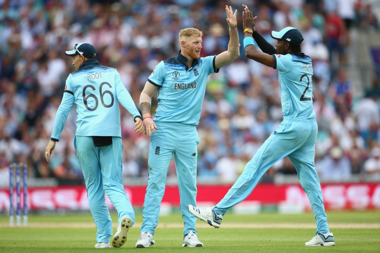 Ben Stokes (C), Joe Root and Jofra Archer of England celebrate after the wicket of Kagiso Rabada of South Africa falls.