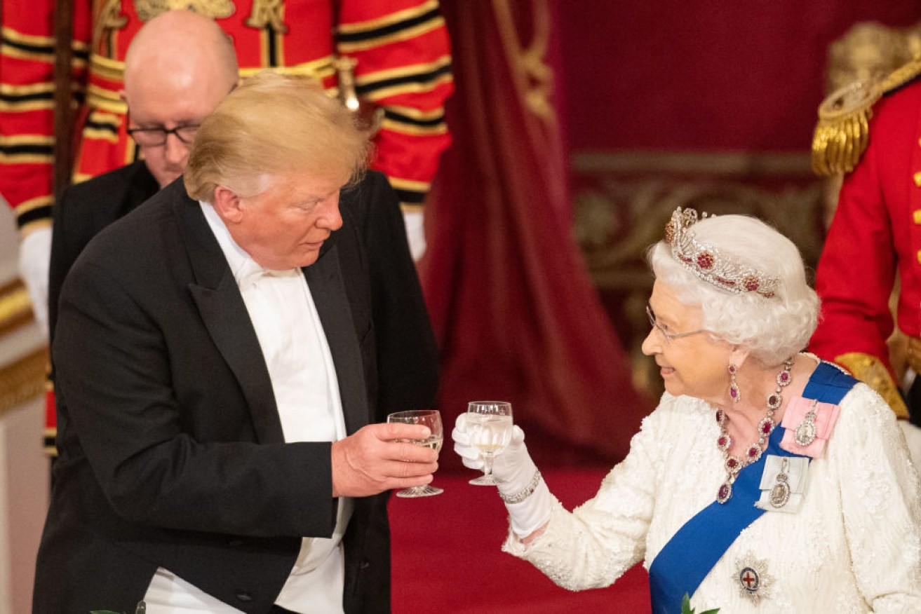 President Donald Trump and Queen Elizabeth II make a toast during a State Banquet at Buckingham Palace. Photo: Getty

