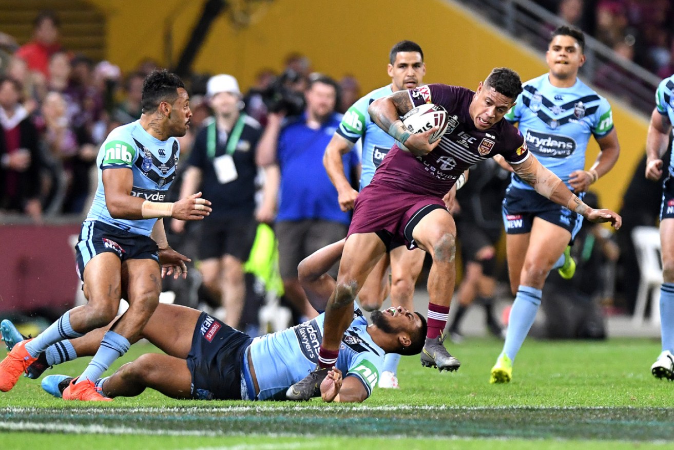Maroons winger Dane Gagai attempts to break away from the NSW defence on Wednesday night.  