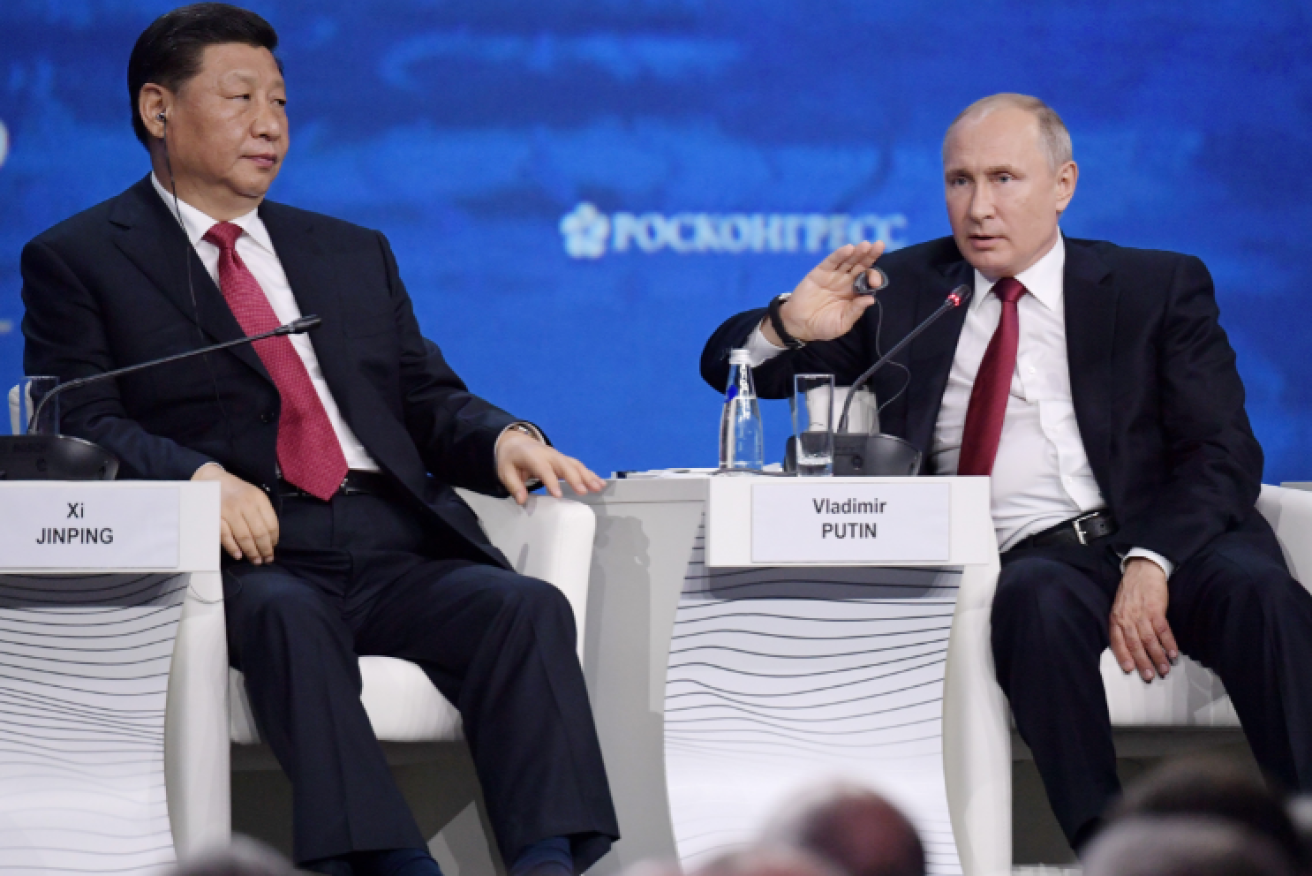 China's President Xi Jinping listens as Vladimir Putin denounces US 'egoism'.