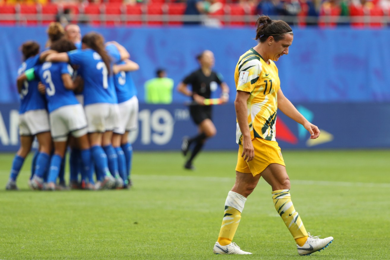Devastation: Lisa De Vanna trudges off the pitch after the Matildas' loss. 
