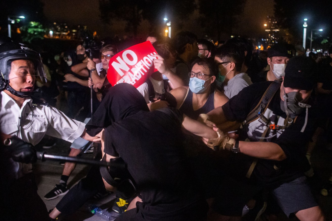 A paper of 'No Extradition' is held by protesters during the clashes with the police at Legislative Council in Hong Kong.