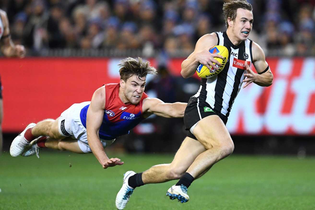 Too fast: Collingwood's Callum Brown runs clear of Melbourne's Jack Viney.