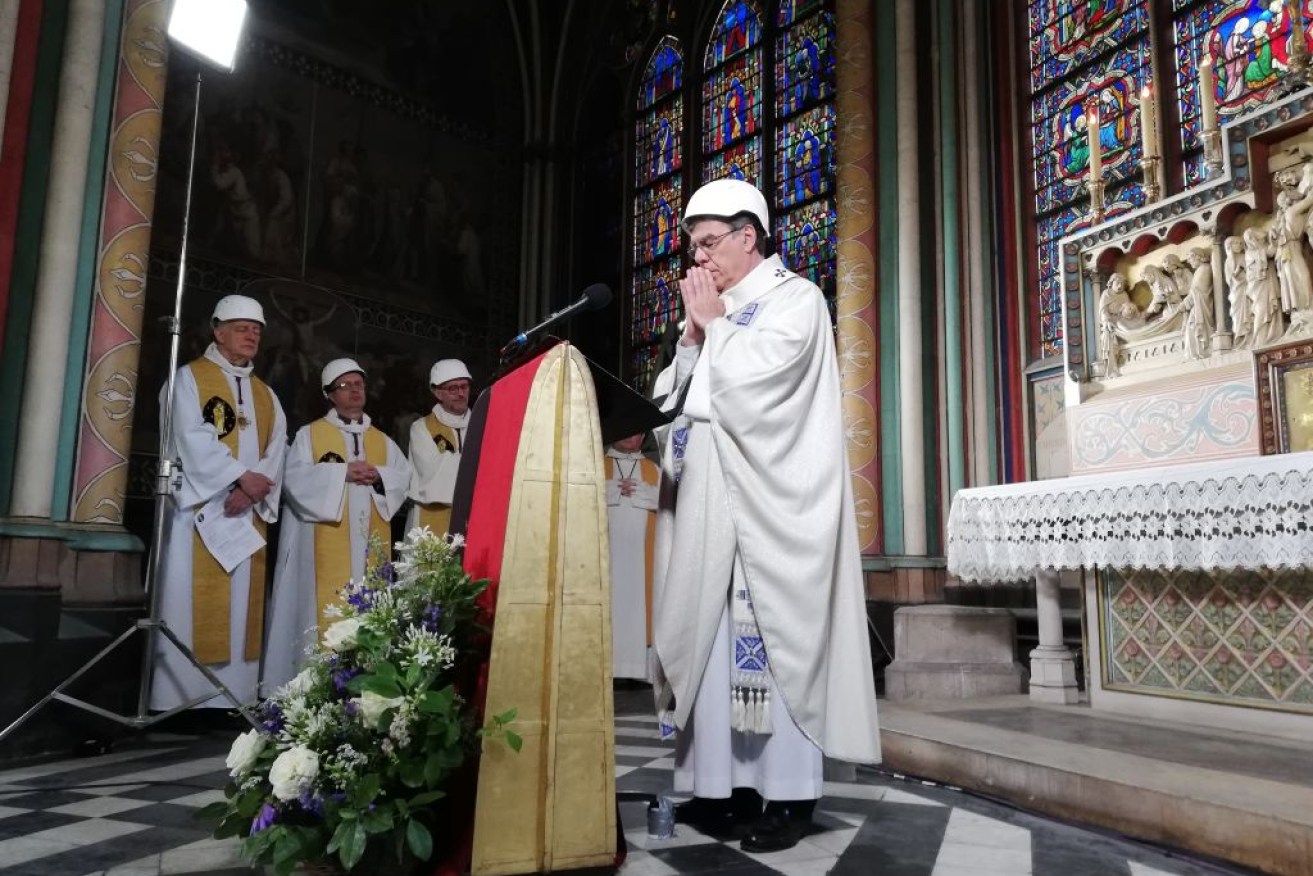 The Archbishop of Paris Michel Aupetit leads the first mass in a side chapel two months to the day after a devastating fire engulfed the Notre-Dame de Paris cathedral on June 15.