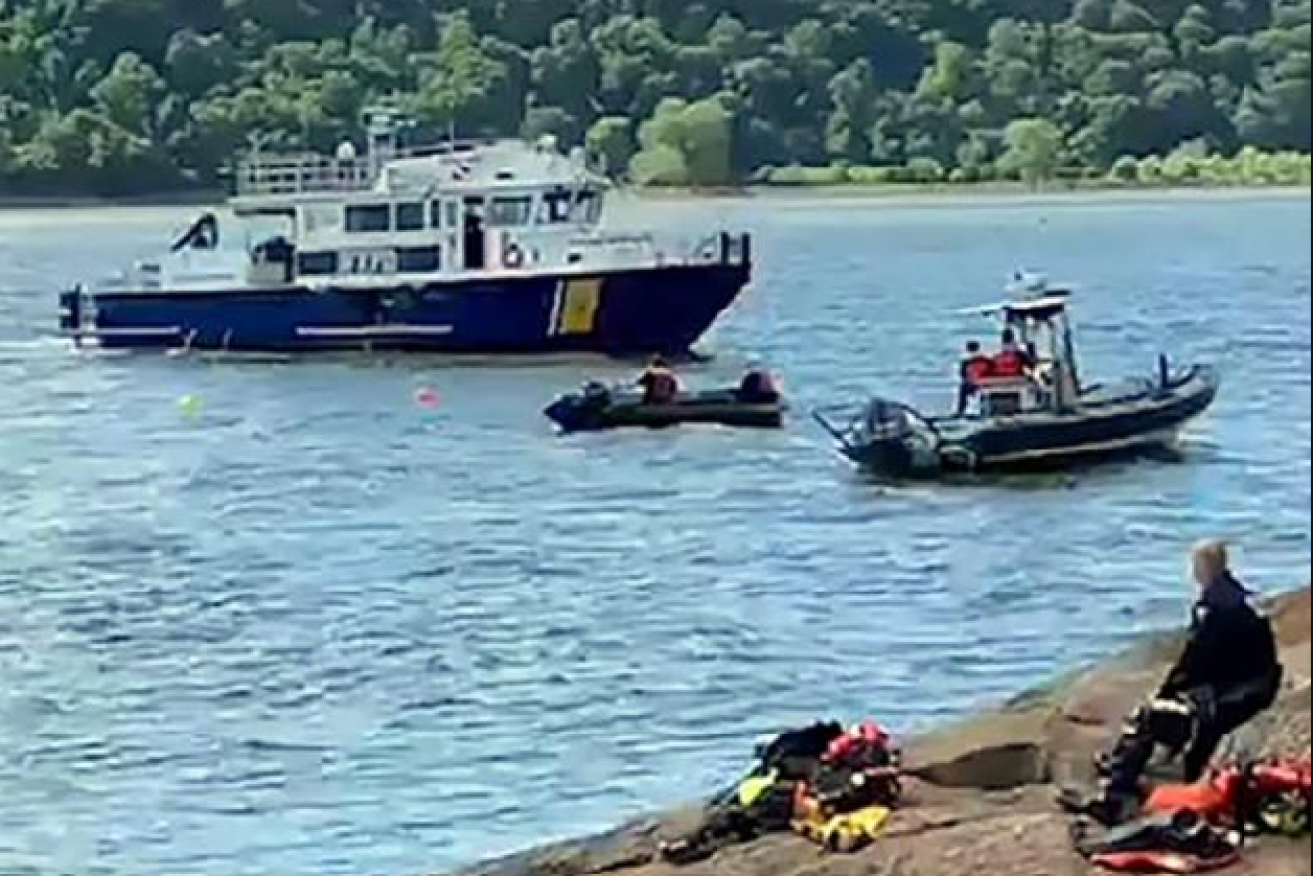 New York boats and divers scour the murky waters of the Hudson for missing medico Charles van der Horst.