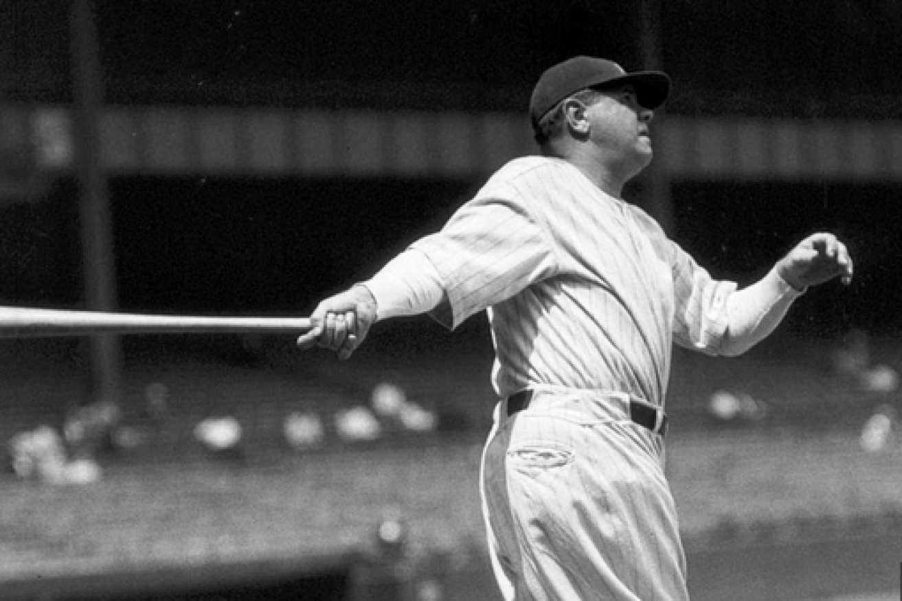 Babe Ruth slugs one over the fence in his baseball heyday.