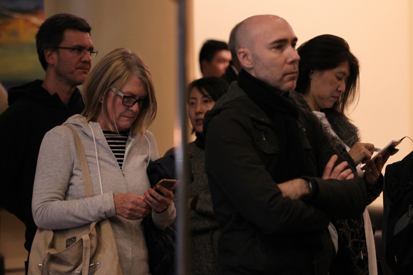 Owners line up to enter an hours-long meeting held at the Holiday Inn on Mascot on Thursday night.