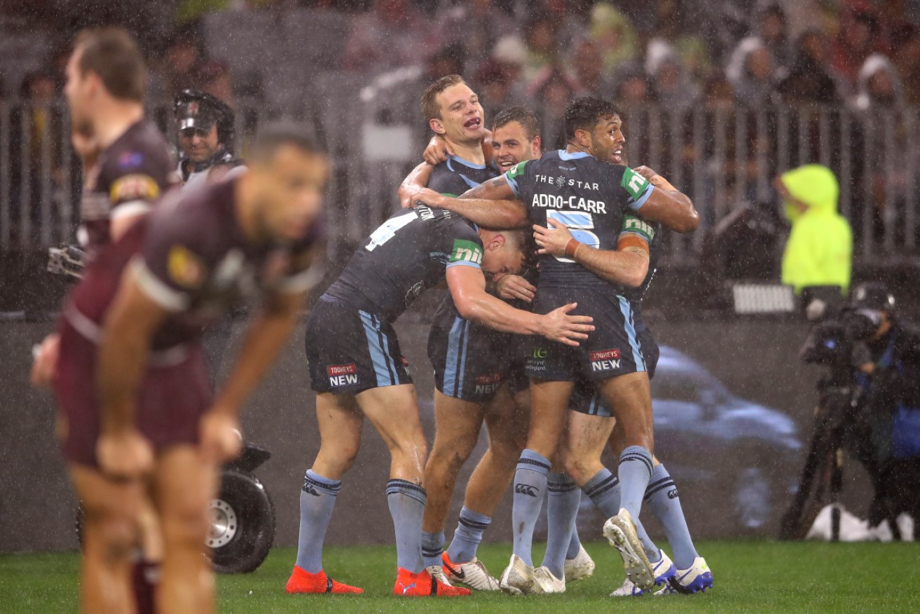 Let it rain: NSW celebrates another try in its resounding win over Queensland. 