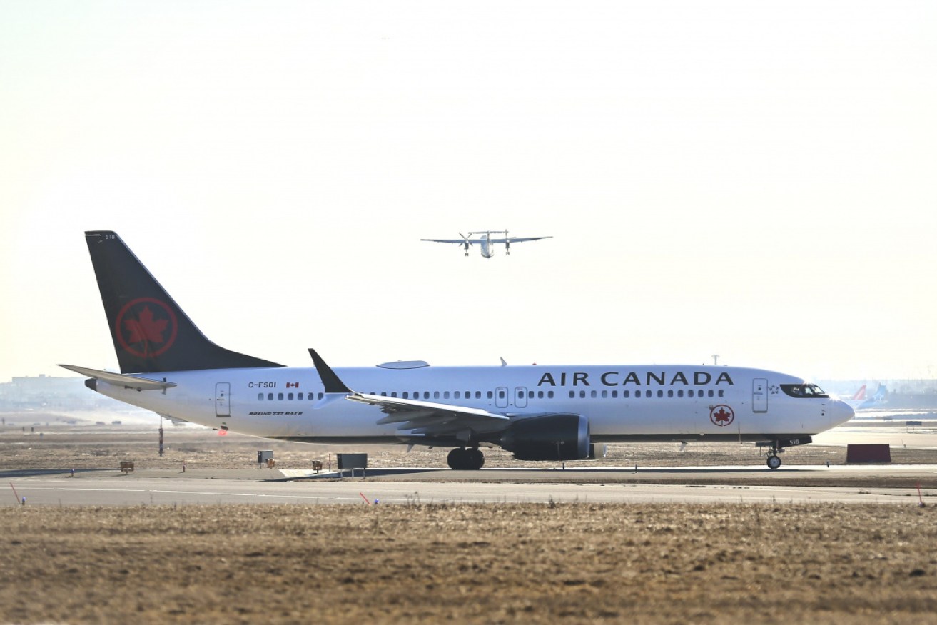 Air Canada says it is reviewing how its flight crew left a passenger in a parked plane.