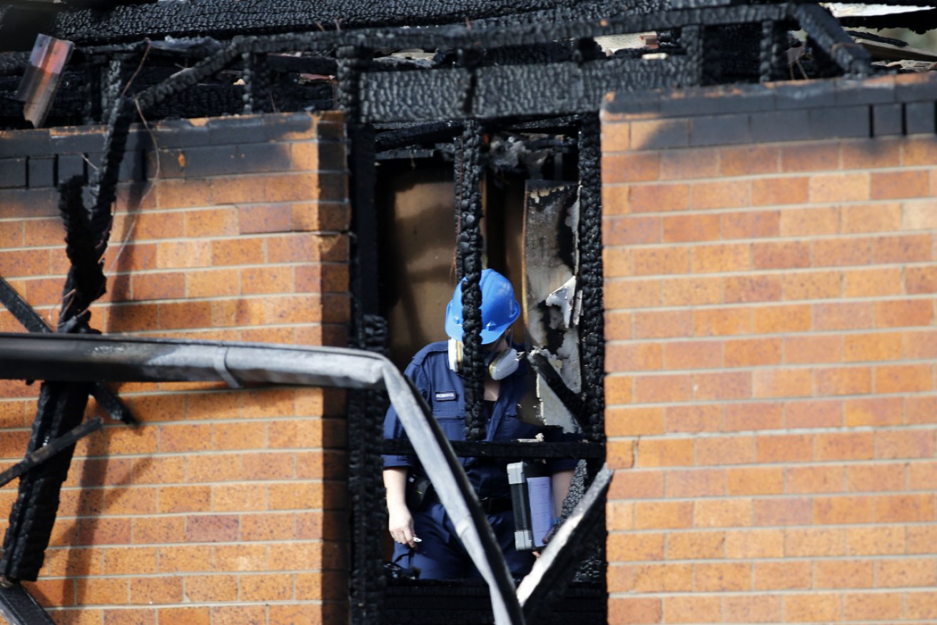 Fire investigators at the Singleton house where the Atkins children died in 2019.
