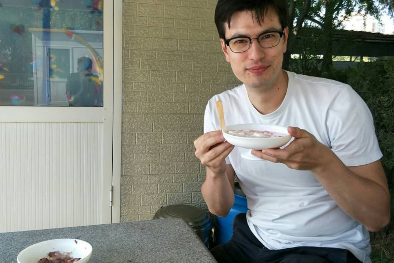 Alek Sigley dining at a restaurant in North Korea. 