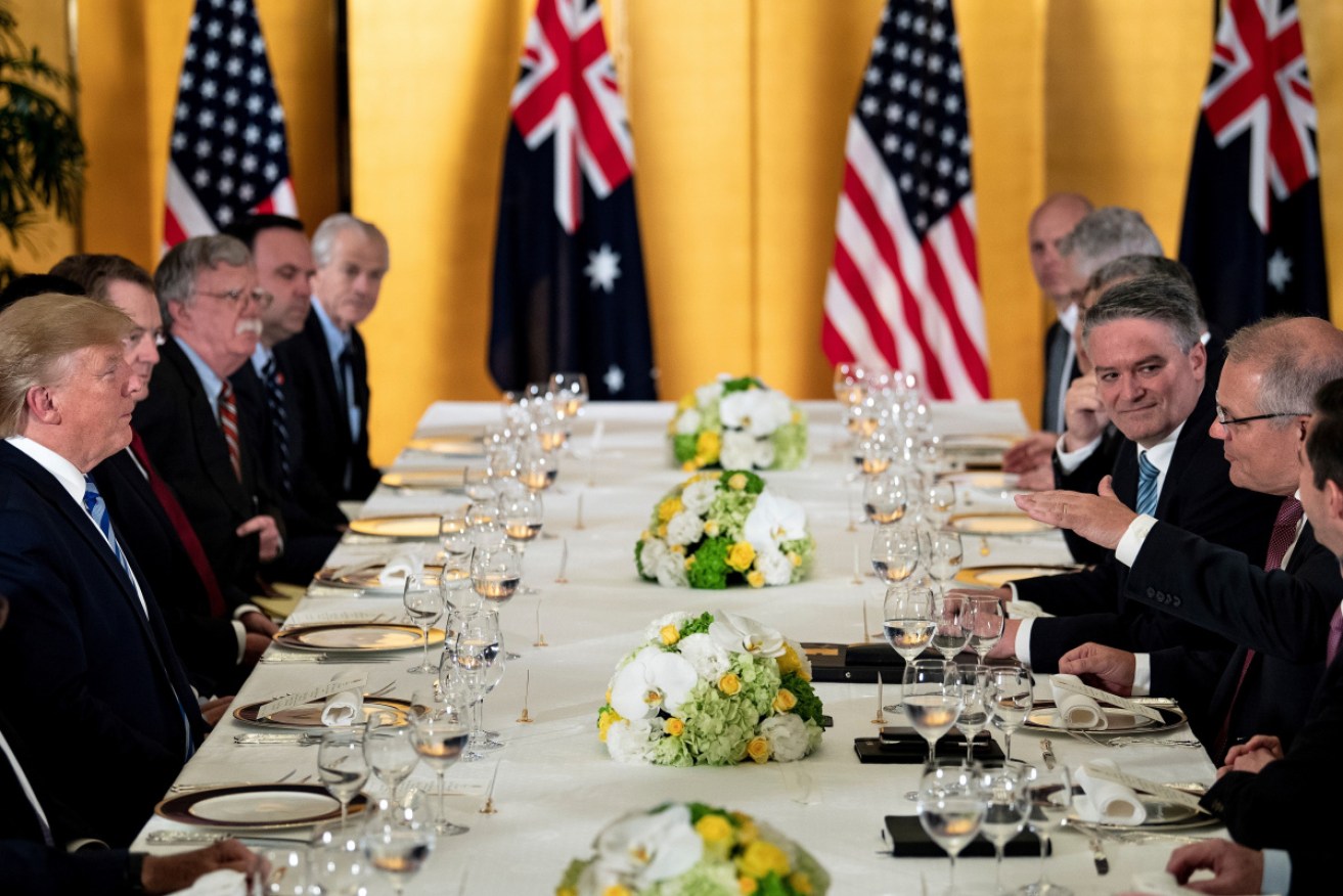 US President Donald Trump (L) and others listen as PM Scott Morrison (R) speaks before a dinner at the Imperial Hotel.