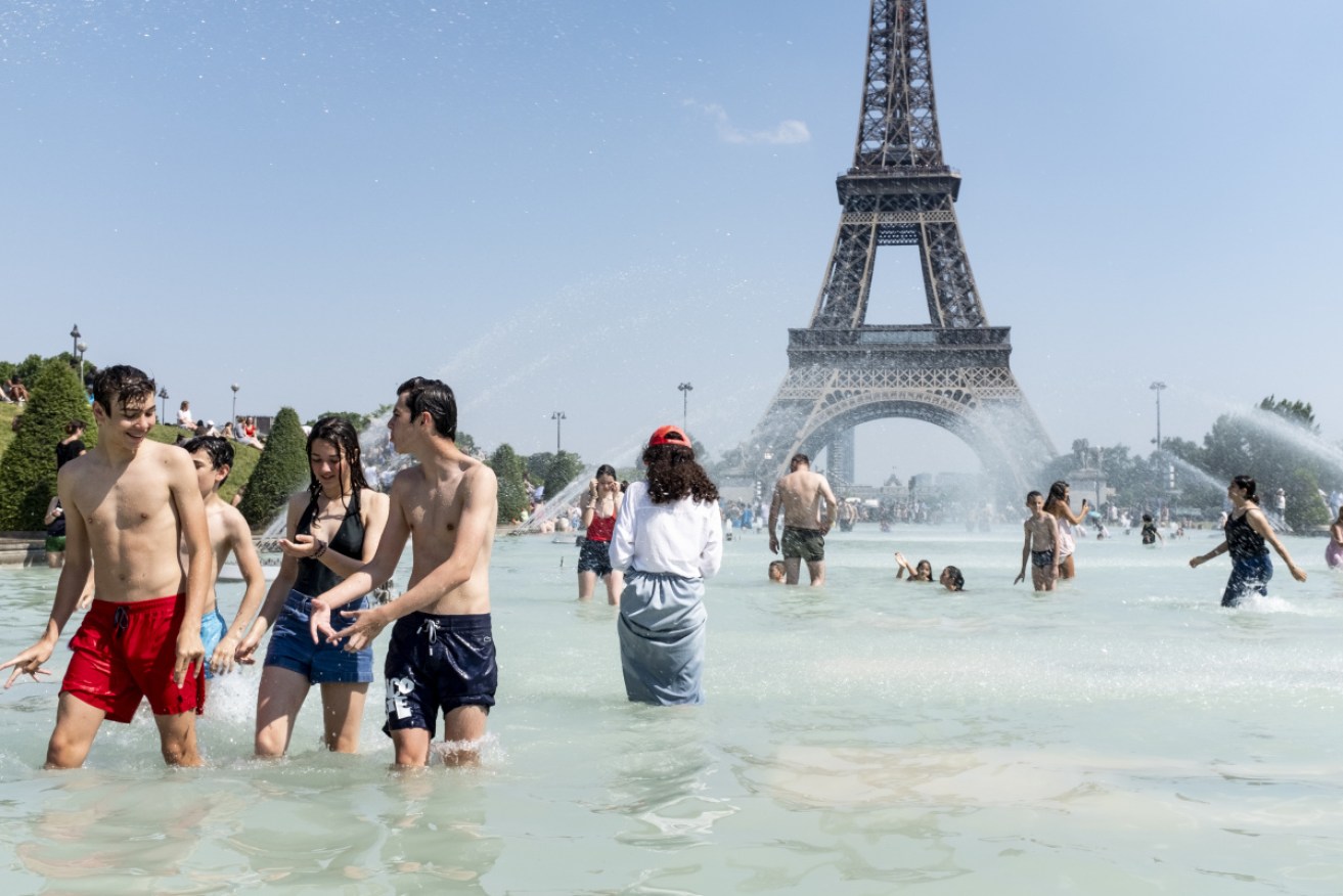 Parisians escape the heat with a dip in the Trocadero Fountain, near the Eiffel Tower.