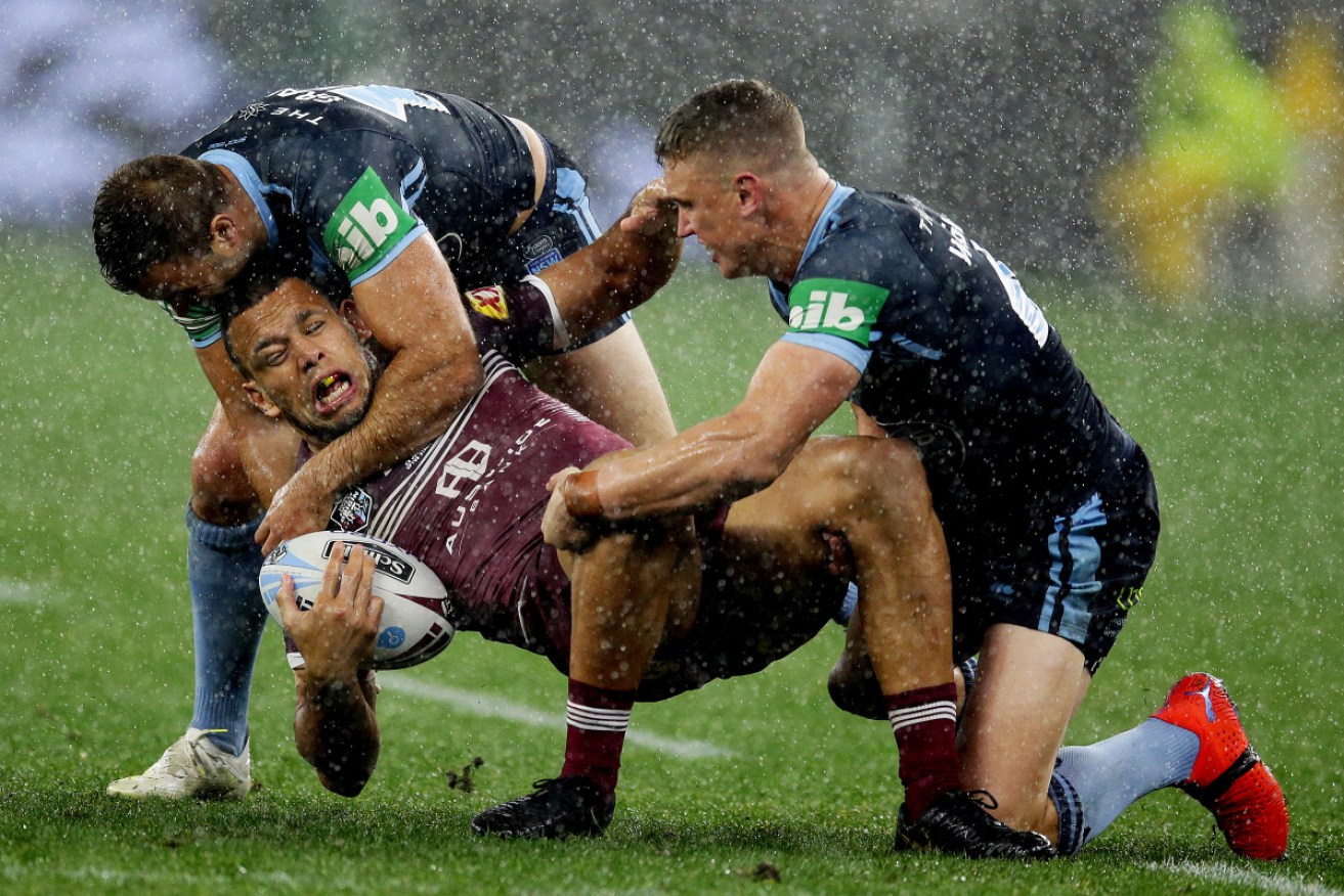 Dirty night: Queensland's Will Chambers is monstered on State of Origin II. 