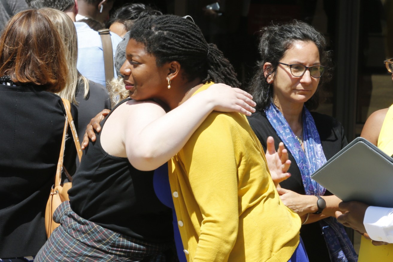 Victims of the 2017 car attack by James Alex Fields hug outside court after his life sentence was handed down.