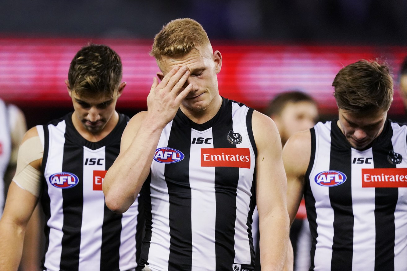 Doh! Collingwood's Adam Treloar laments the upset loss to the Roos. 