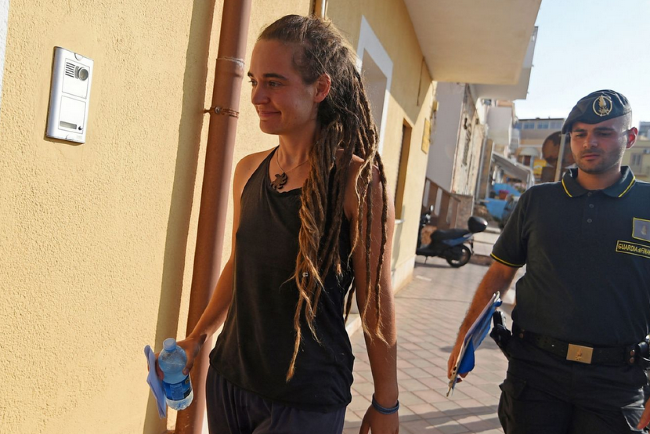 Asylum-seeker rescue captain Carola Rackete is taken into custody in Lampedusa.
