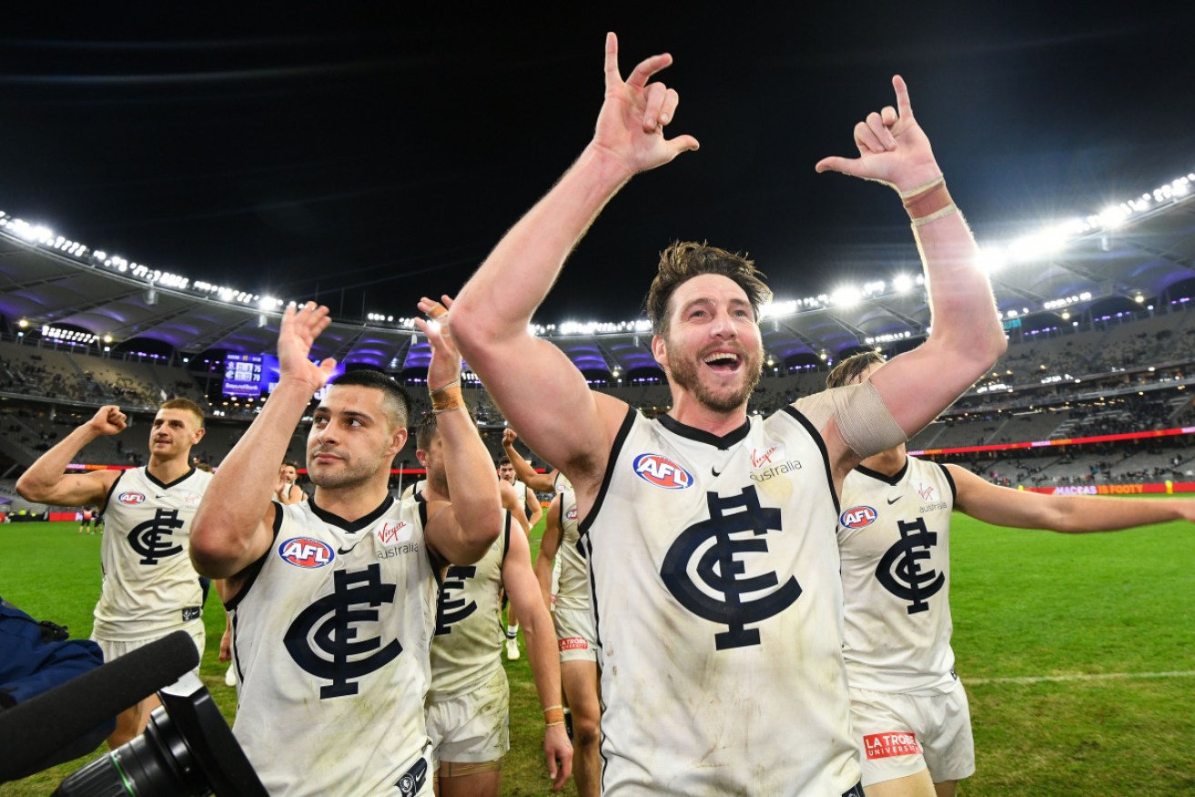 That was close: Carlton players celebrate their memorable win. 