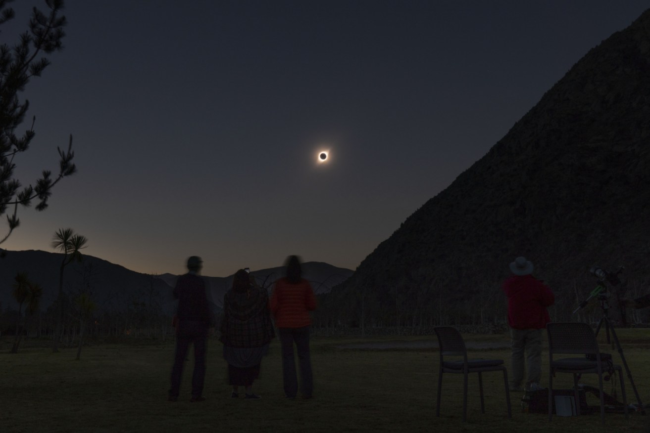 Tourists watch the eclipse in the Chilean desert.