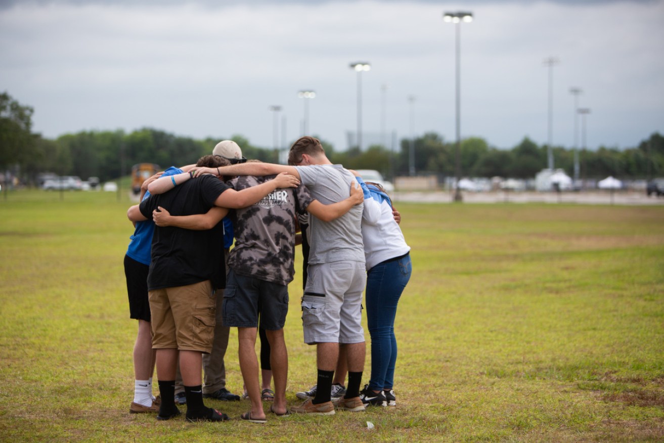Students mourn the loss of colleagues after the shooting at Santa Fe High School on May 18, 2018.