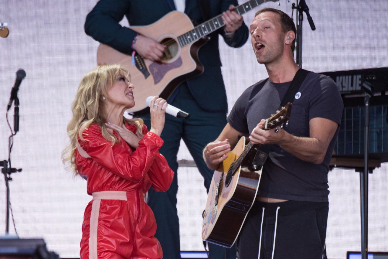Kylie performs with Chris Martin from Coldplay, which has also had seven No.1 songs.