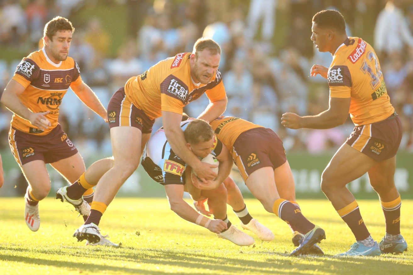 Cronulla and Brisbane players in the heat of battle on Sunday. 