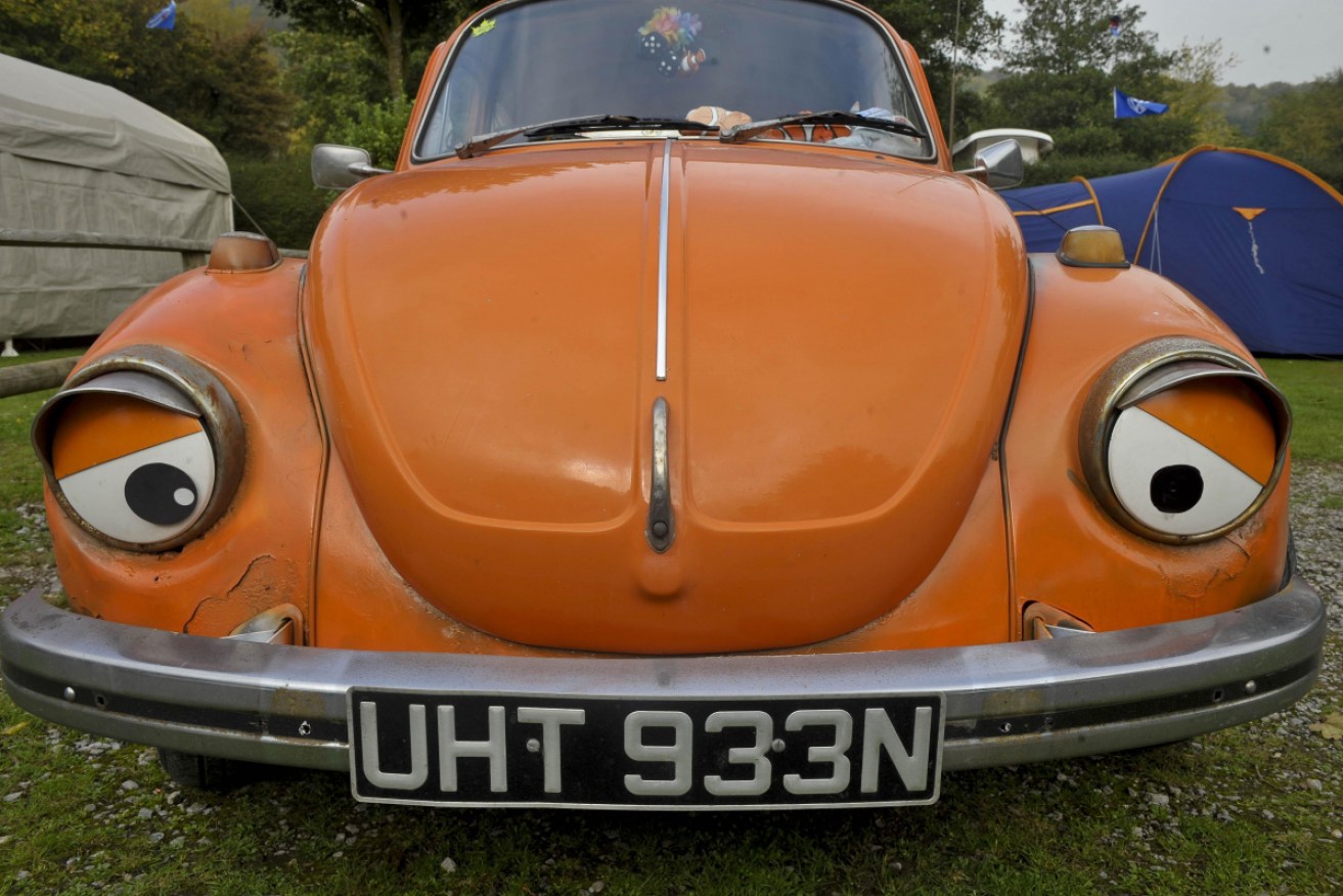 False eyes are stuck onto the headlights of a VW Beetle at the Oktoberfest VW show in Cheddar, Somerset.