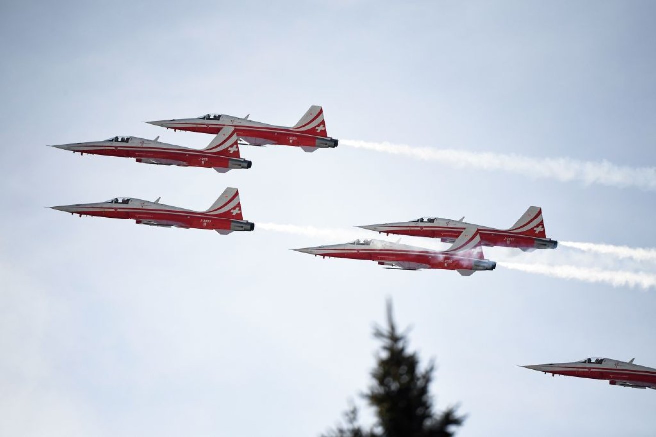 Swiss airforce aerobatic team Patrouille Suisse doing a routine over the ski resort in the Swiss Alps.