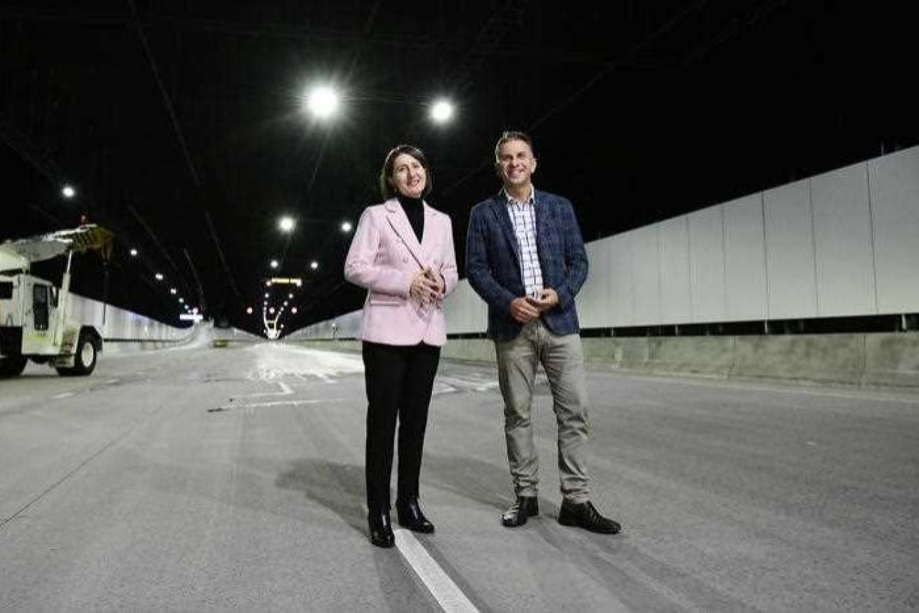Gladys Berejiklian in a pink jacket in a motorway tunnel with Andrew Constance
PHOTO: Premier Gladys Berejiklian and Transport Minister Andrew Constance show off the new tunnels. 