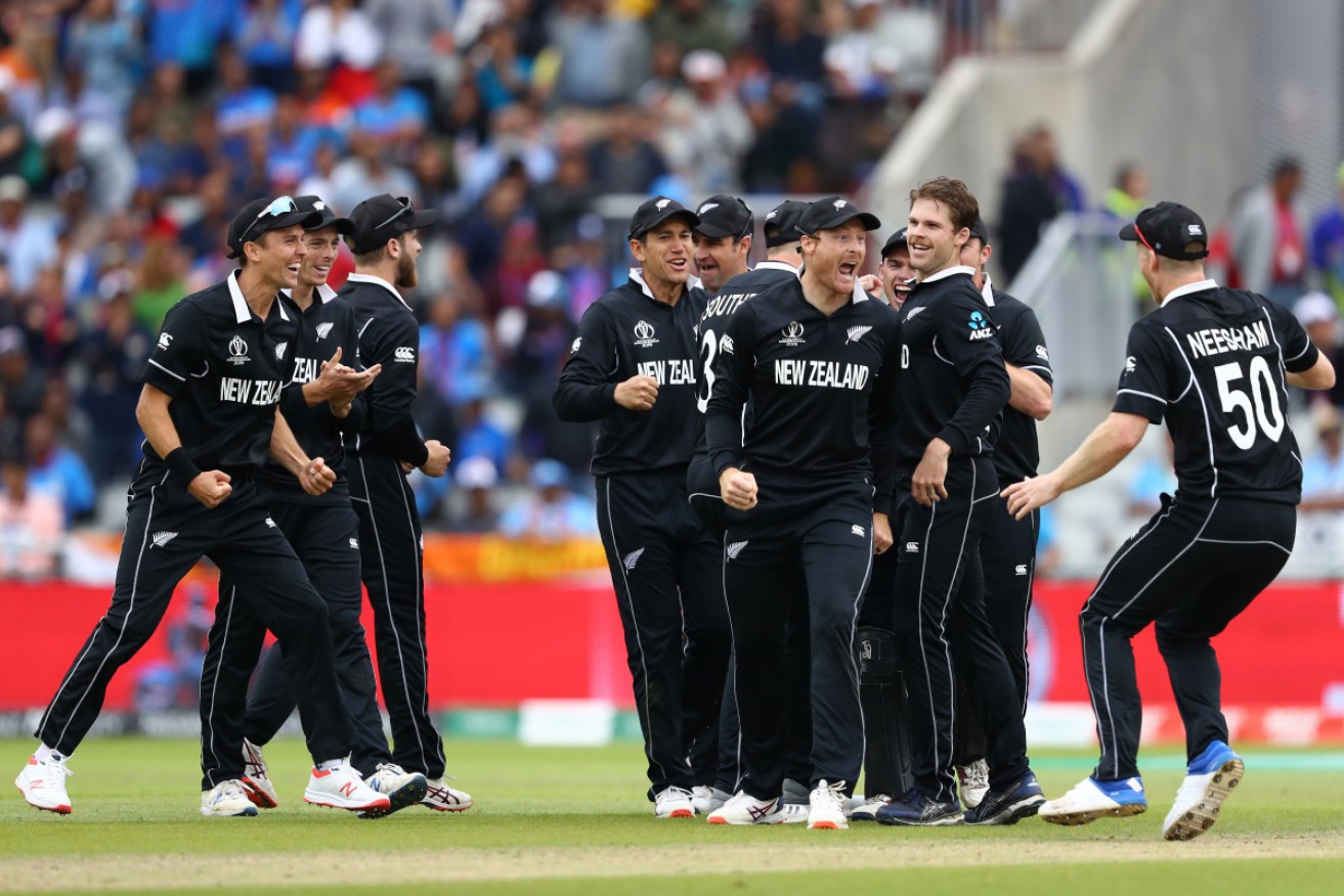 Martin Guptill celebrates with Jimmy Neesham (r) and team mates after running out MS Dhoni during the Semi-Final.