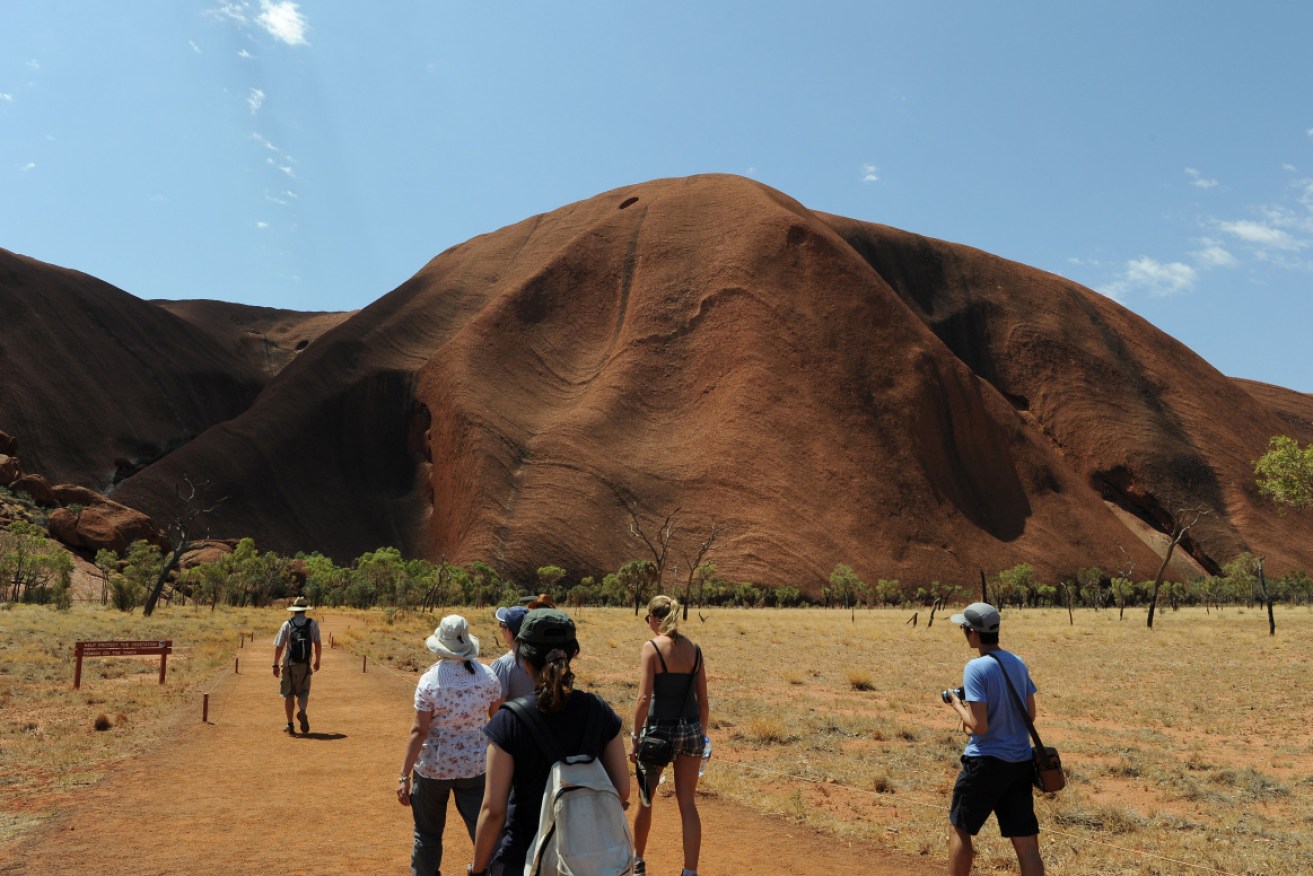 Tourists are rushing to climb Uluru before the ban at the end of October