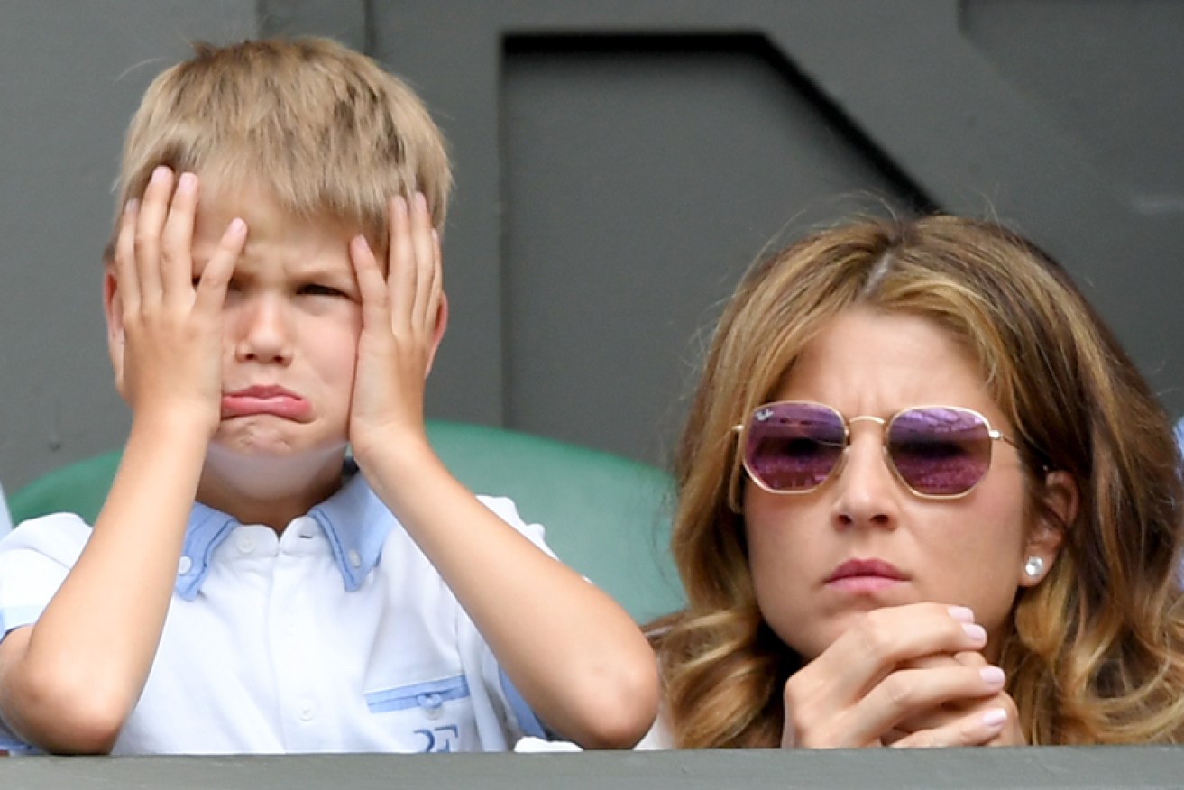 Mirka Federer and one of her sons watch husband and father Roger Federer at Wimbledon on July 2.