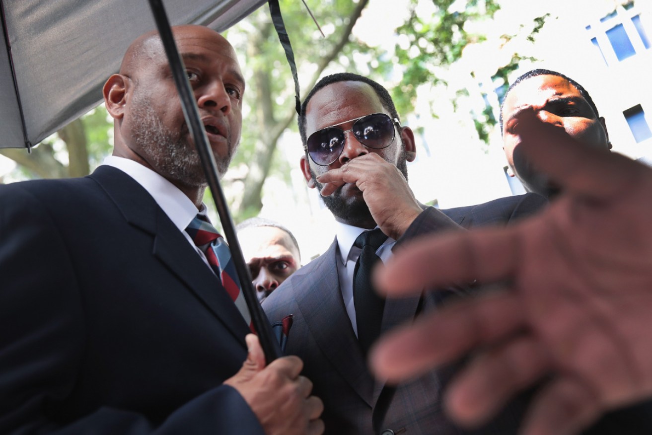 R Kelly leaves a Chicago courtroom after a hearing in June on earlier charges.