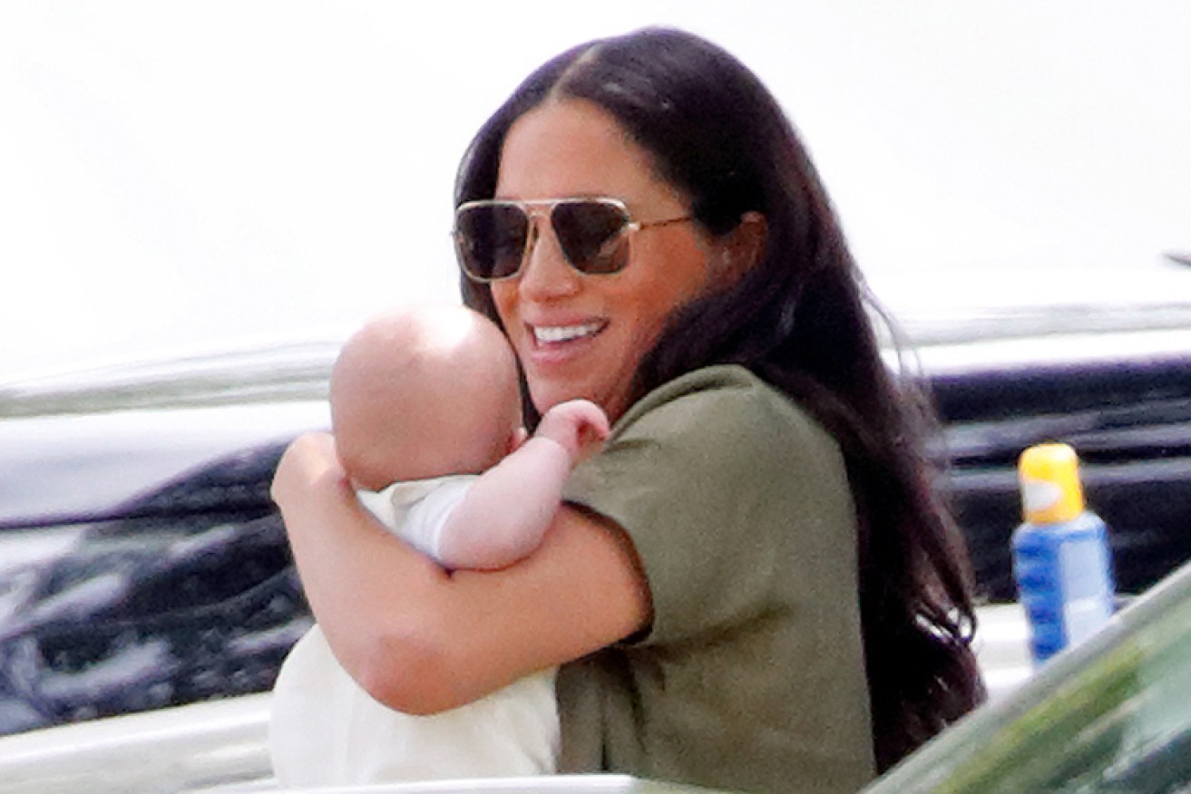 Meghan Markle carries baby son Archie at a Surrey polo club on July 10.