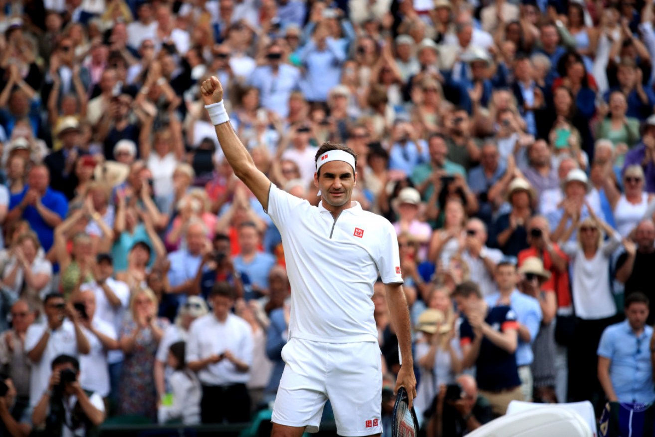 Roger Federer celebrates victory following his 4-set match against Rafael Nadal at Wimbledon.
 