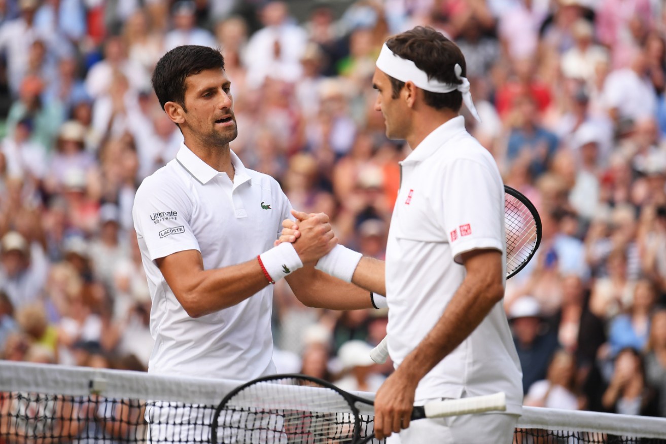 Novak Djokovic greets Roger Federer at the net after their epic Wimbledon match last year.