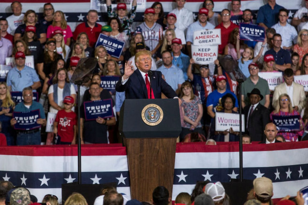 Donald Trump says he does not agree with his supporters who chanted "send her back" against a Somali-born congresswoman at his re-election rally in North Carolina.