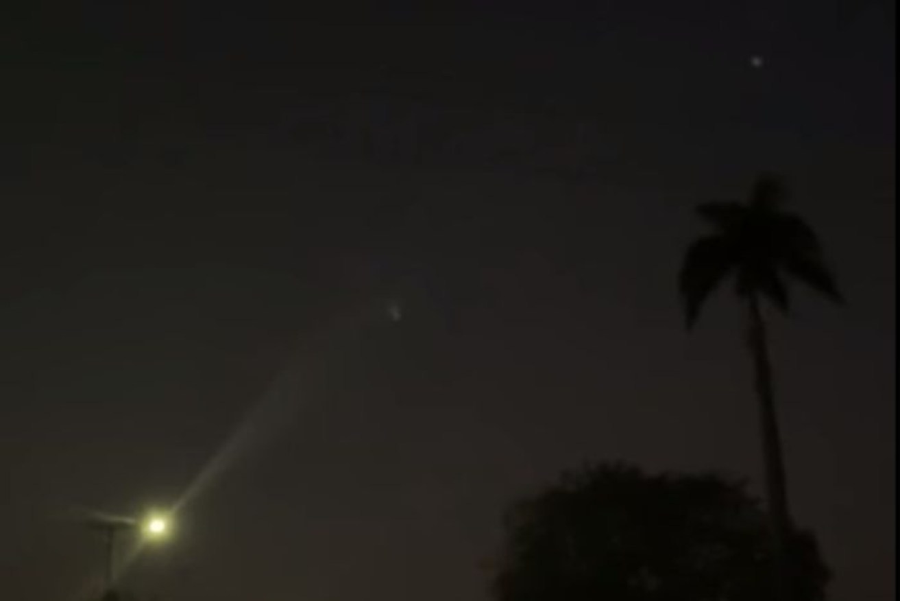 The bright light (directly above the palm tree) was also spotted from near Kalkarindji, NT.