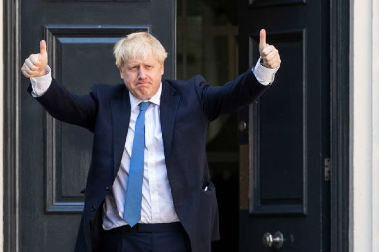 Boris Johnson confirms his leadership win with a thumbs up.