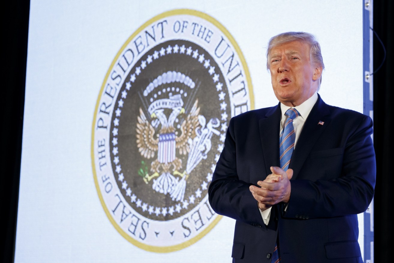 The doctored presidential seal, with a Russian eagle clutching cash and golf clubs, was displayed on Tuesday at a student rally.