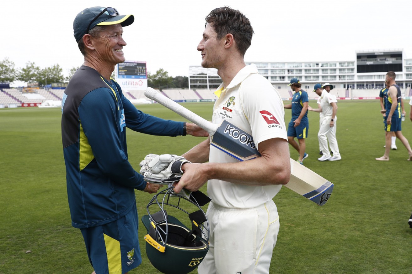 Australian batting coach Graeme Hick congratulates Cameron Bancroft after his unbeaten knock of 93. 