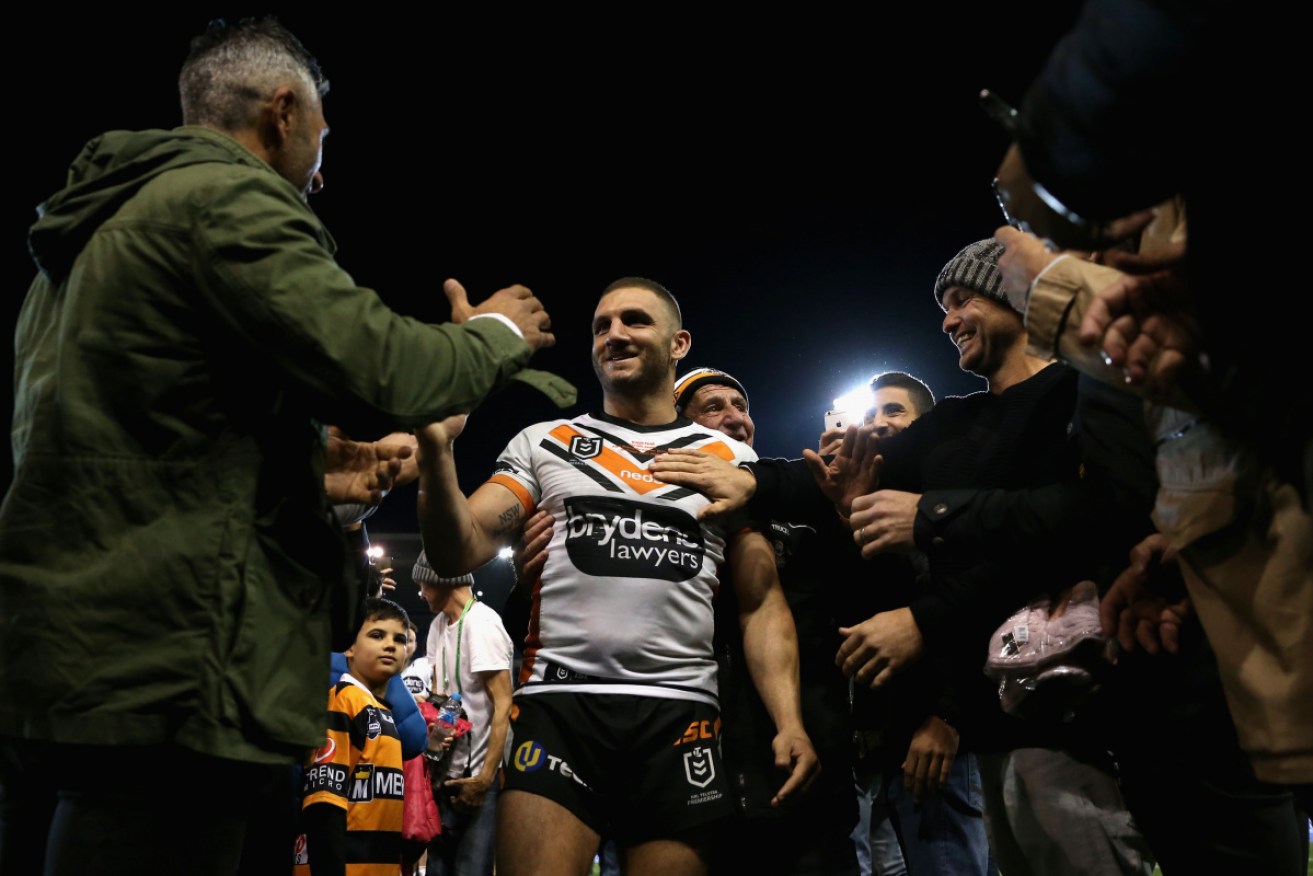 Robbie Farah is congratulated after his 300th game. 