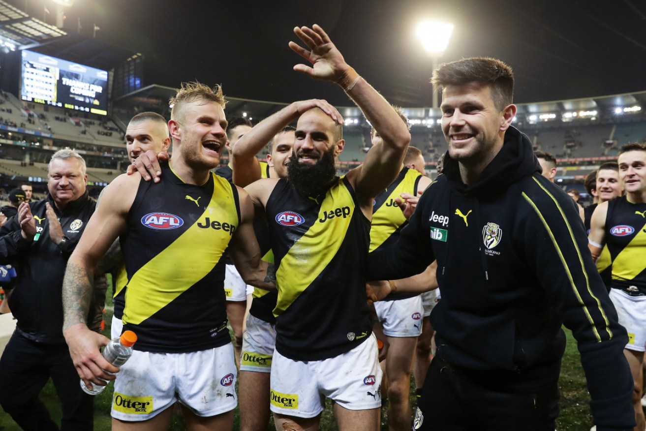 Bachar Houli is acknowledged by his teammates in his milestone game. 